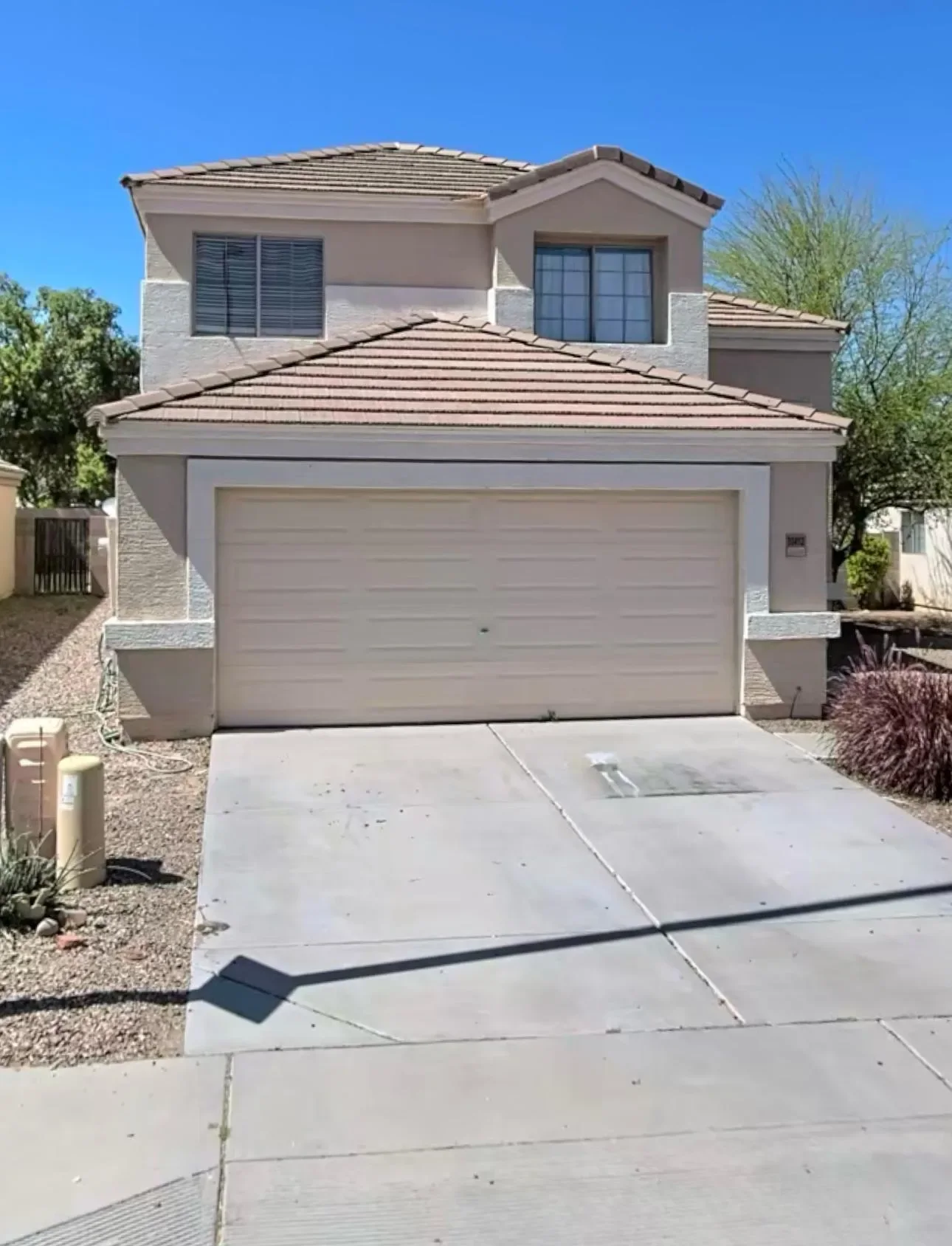 Two-story stucco home with a tile roof and two-car garage in Phoenix, Arizona